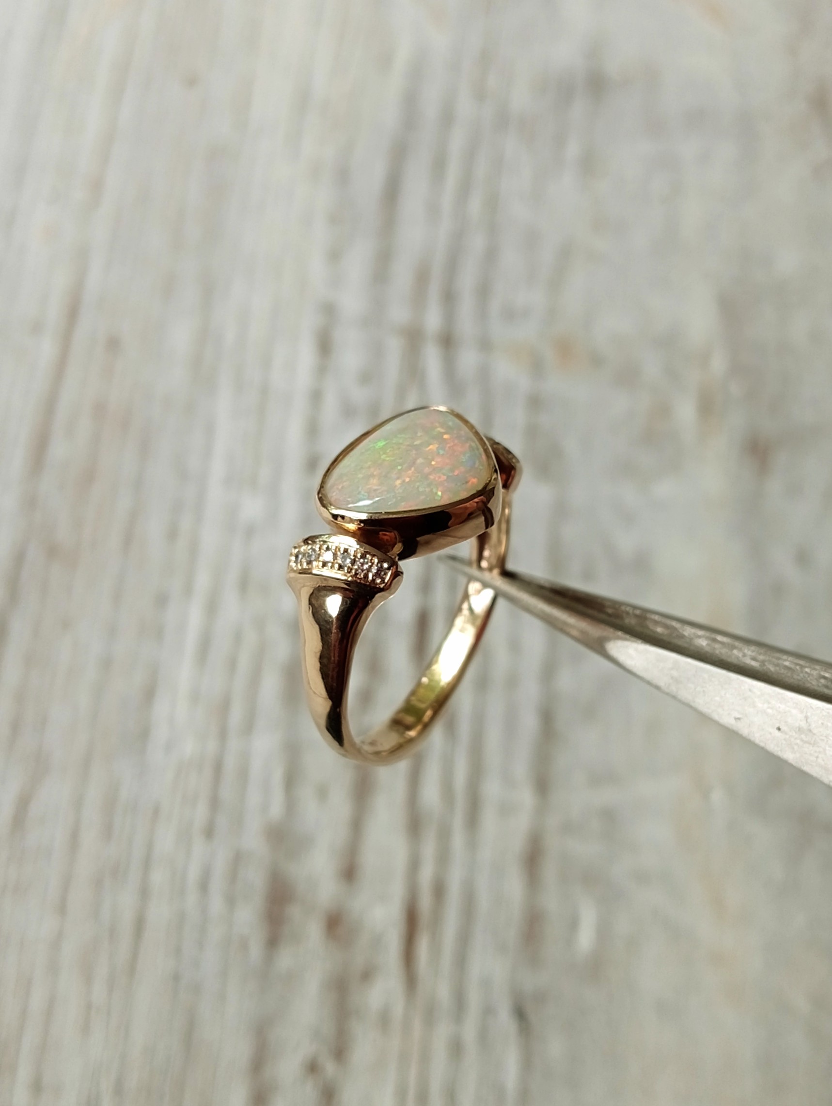 large solid opal with diamond-studded side-bands