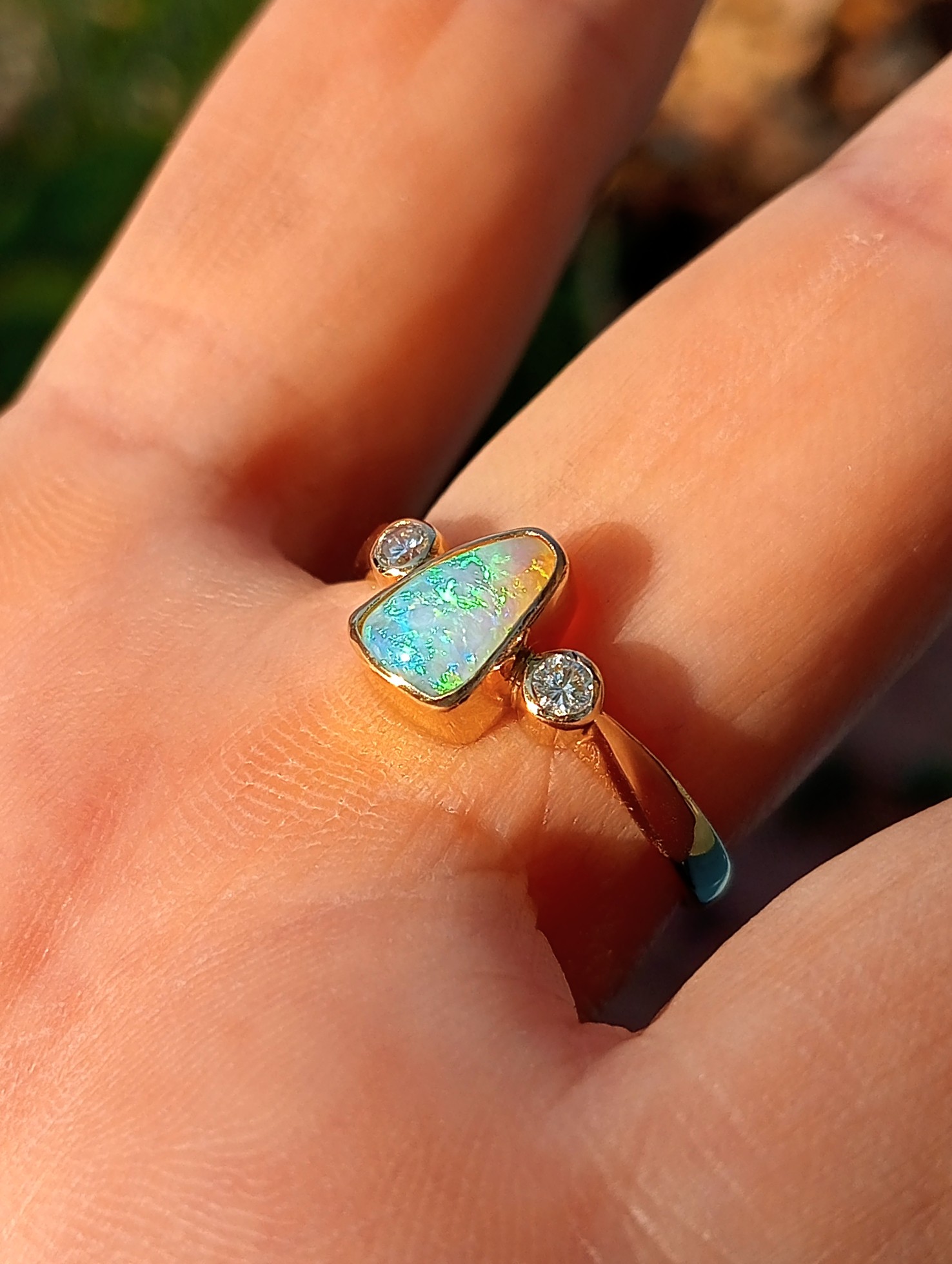 bezel set opal and diamond ring